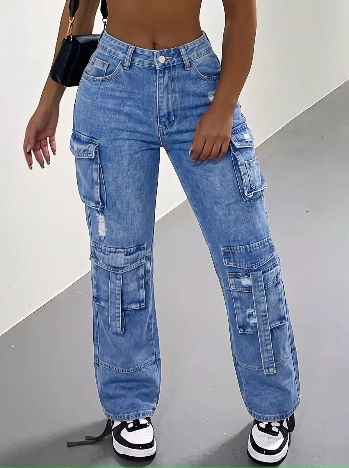 High-waisted dark blue distressed cargo jeans, front view