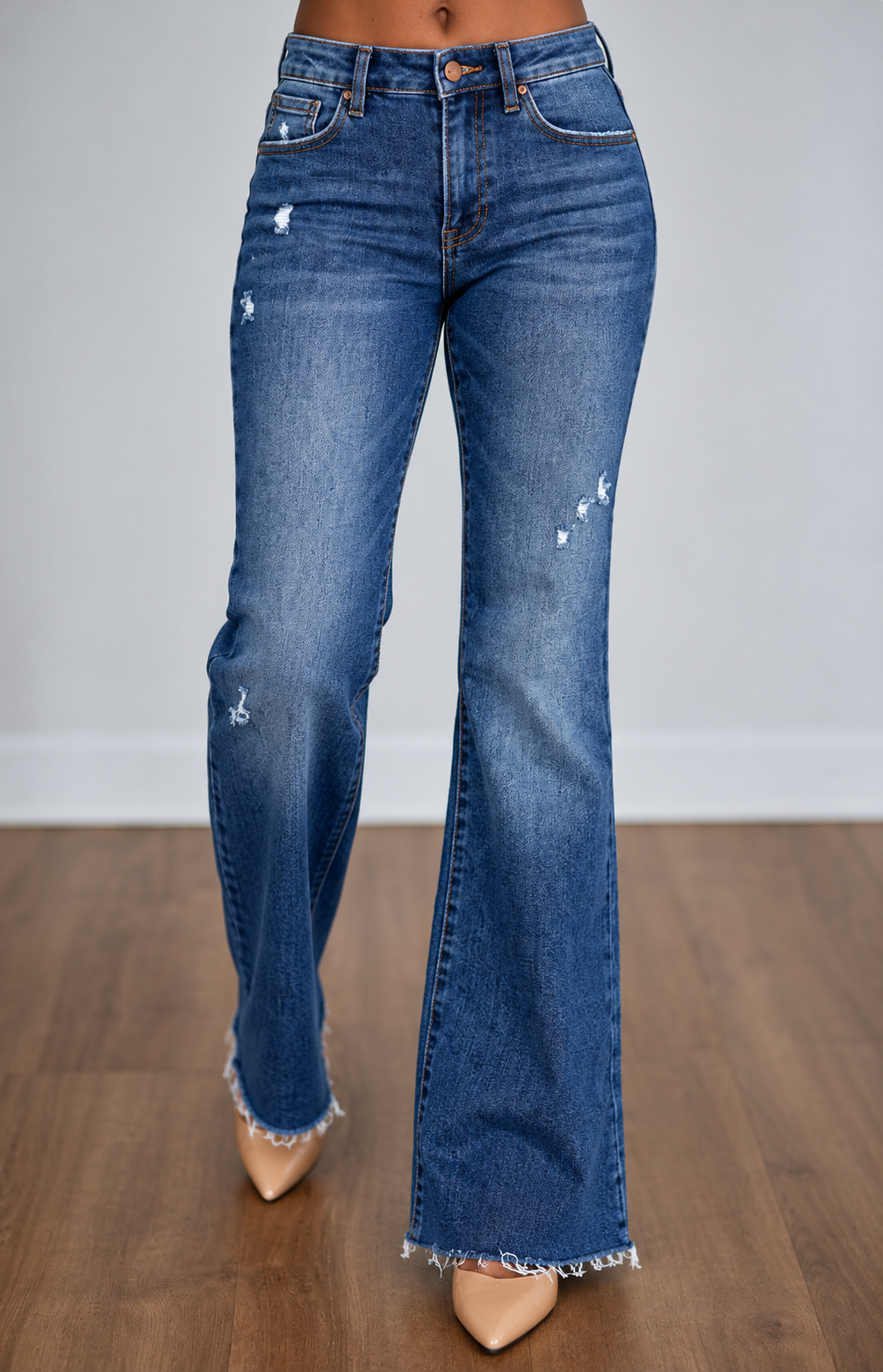 Risen distressed flare jeans modeled on brown skin, front view